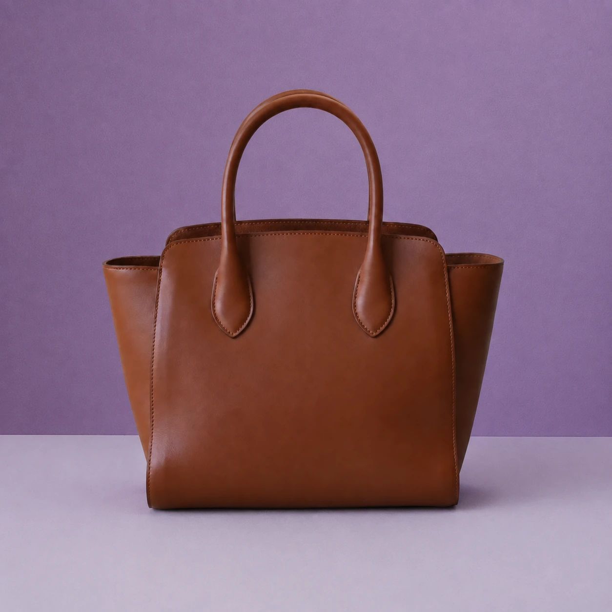 Handbag in a purple studio setting
